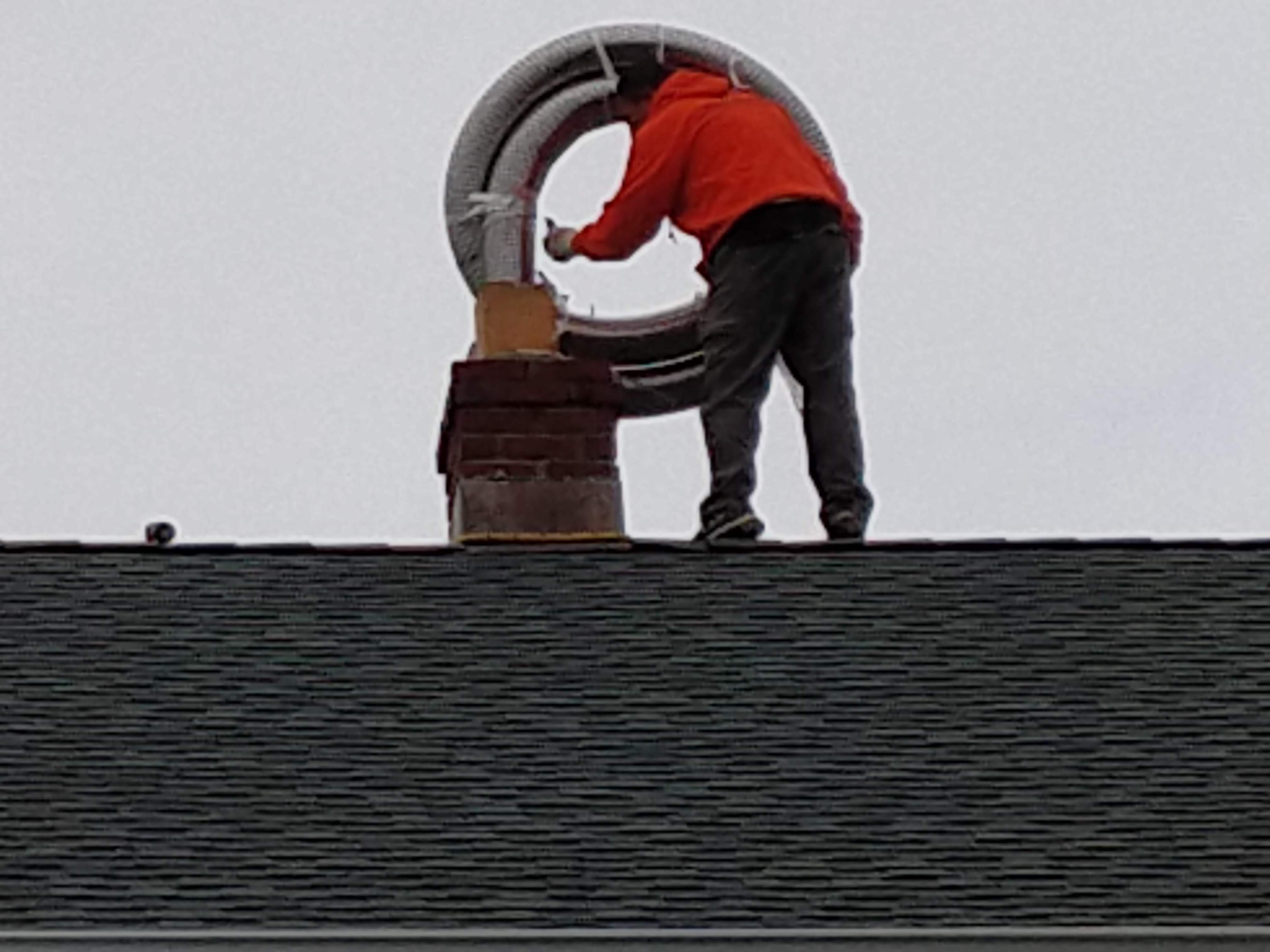Flexible stainless chimney liner being installed in Lindenhurst, New York